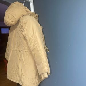 Tan coat with patch on sleeve. Runs small.